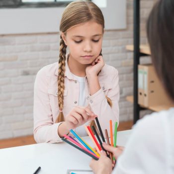 sad-little-girl-choosing-the-colored-pencils-hold-by-female-psychologist-1.jpg